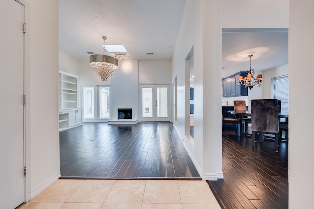 1600 Railhead Pl, Carrollton, TX 75007 - unfurnished living room with a chandelier, plenty of natural light, and hardwood / wood-style flooring