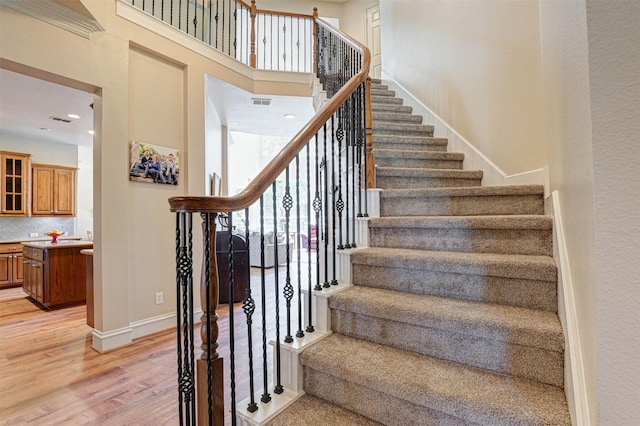12332 Green Ash Dr, Fort Worth, TX 76244 - stairway with wood finished floors, a high ceiling, baseboards, and recessed lighting