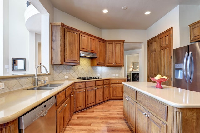 12332 Green Ash Dr, Fort Worth, TX 76244 - kitchen with appliances with stainless steel finishes, a sink, under cabinet range hood, brown cabinets, and recessed lighting