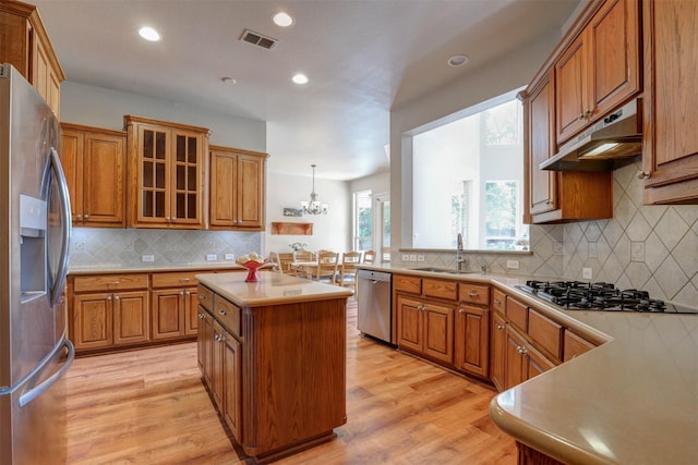12332 Green Ash Dr, Fort Worth, TX 76244 - kitchen featuring appliances with stainless steel finishes, a sink, under cabinet range hood, brown cabinetry, and recessed lighting