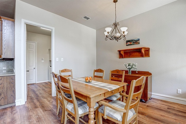 12332 Green Ash Dr, Fort Worth, TX 76244 - dining space featuring light wood-type flooring, a chandelier, and baseboards
