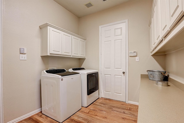 12332 Green Ash Dr, Fort Worth, TX 76244 - laundry room featuring cabinet space, washing machine and dryer, light wood-style floors, and baseboards