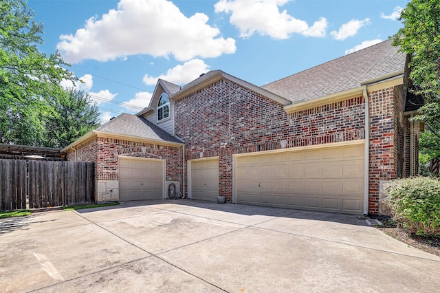 12332 Green Ash Dr, Fort Worth, TX 76244 - traditional-style house featuring brick siding, a shingled roof, concrete driveway, and fence