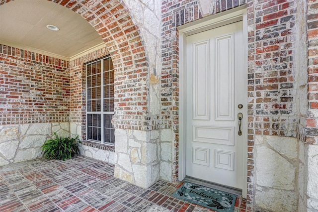 12332 Green Ash Dr, Fort Worth, TX 76244 - view of exterior entry featuring brick siding, stone siding, and a porch