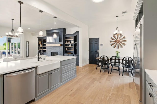 3320 S Fm 548, Royse City, TX 75189 - kitchen with stainless steel appliances, a chandelier, light countertops, a fireplace, and recessed lighting
