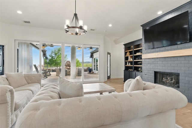 3320 S Fm 548, Royse City, TX 75189 - living area featuring a chandelier, light wood-style floors, recessed lighting, built in shelves, and a brick fireplace