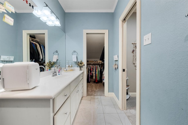 306 Winding Creek Ln, Mcgregor, TX 76657 - bathroom with vanity, ornamental molding, baseboards, and a walk in closet