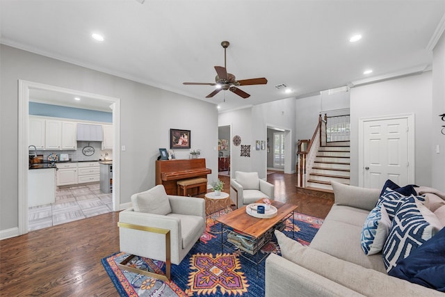 306 Winding Creek Ln, Mcgregor, TX 76657 - living area featuring stairs, a ceiling fan, light wood-style floors, recessed lighting, and ornamental molding