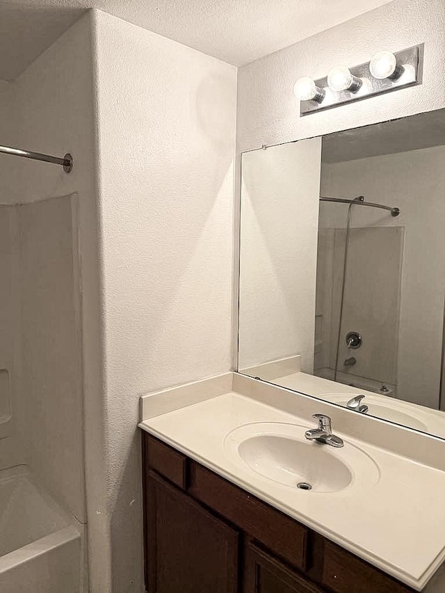 10028 Quail Glen Dr, Fort Worth, TX 76140 - full bathroom with a textured wall, vanity, bathtub / shower combination, and a textured ceiling