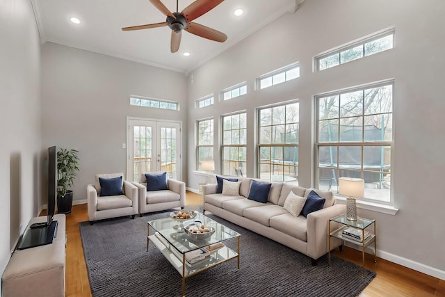 6723 Blessing Dr, Dallas, TX 75214 - living area featuring healthy amount of natural light, wood finished floors, a high ceiling, recessed lighting, and baseboards