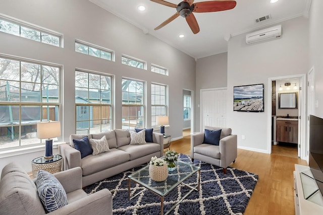 6723 Blessing Dr, Dallas, TX 75214 - living room featuring a high ceiling, a ceiling fan, healthy amount of natural light, a wall unit AC, and recessed lighting