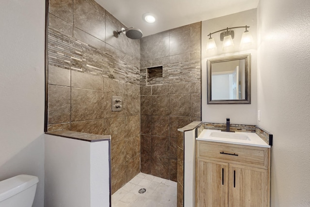 6723 Blessing Dr, Dallas, TX 75214 - bathroom featuring a tile shower, toilet, and vanity