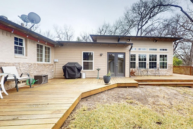 6723 Blessing Dr, Dallas, TX 75214 - back of house with stone siding, french doors, and a deck