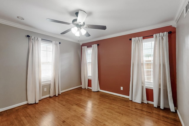 6723 Blessing Dr, Dallas, TX 75214 - spare room featuring light wood-style flooring, a ceiling fan, crown molding, and baseboards