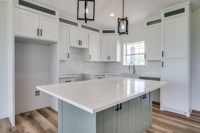 488 Klas Rd, Sherman, TX 75092 - kitchen with recessed lighting, glass insert cabinets, light stone counters, a center island, and backsplash
