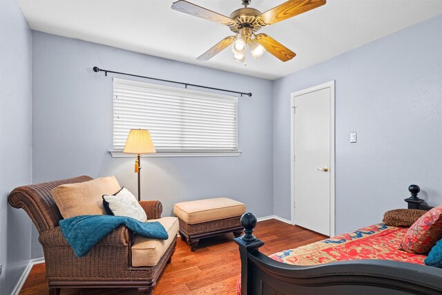 bedroom featuring wood finished floors, ceiling fan, and baseboards