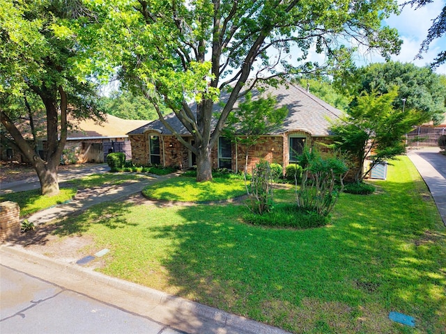 view of front of home with brick siding and a shingled roof