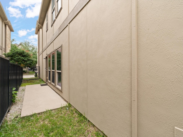 8821 Whitehead St, Mckinney, TX 75070 - view of property exterior with fence, stucco siding, and a patio