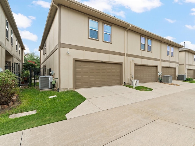 8821 Whitehead St, Mckinney, TX 75070 - view of front of home featuring central AC, driveway, a garage, and fence