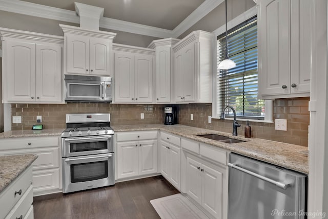 kitchen featuring stainless steel appliances, a sink, white cabinetry, and crown molding