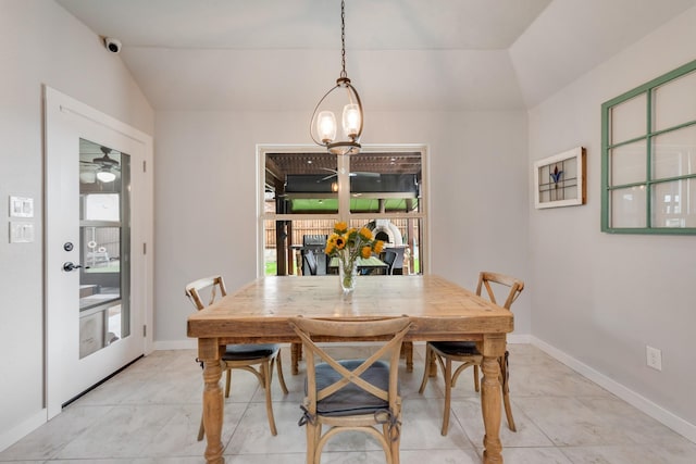 dining area with healthy amount of natural light, baseboards, and vaulted ceiling