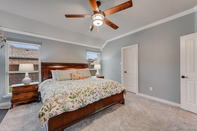 carpeted bedroom featuring crown molding, vaulted ceiling, baseboards, and a ceiling fan