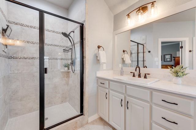 full bathroom featuring a stall shower and vanity