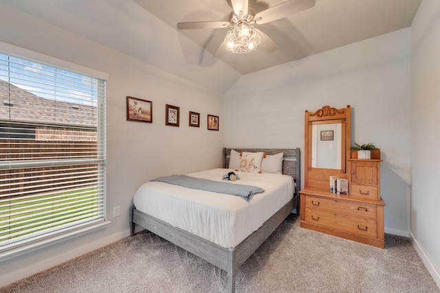 bedroom featuring light colored carpet, lofted ceiling, ceiling fan, and baseboards
