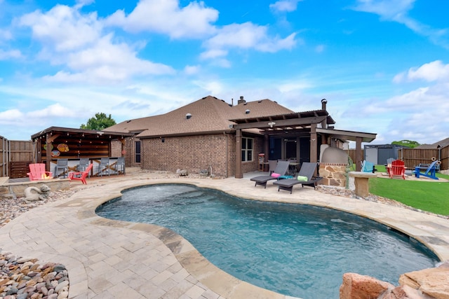 view of swimming pool with a patio area, a fenced backyard, and a pergola