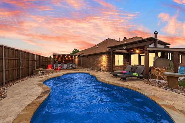 view of swimming pool with a patio and a fenced backyard