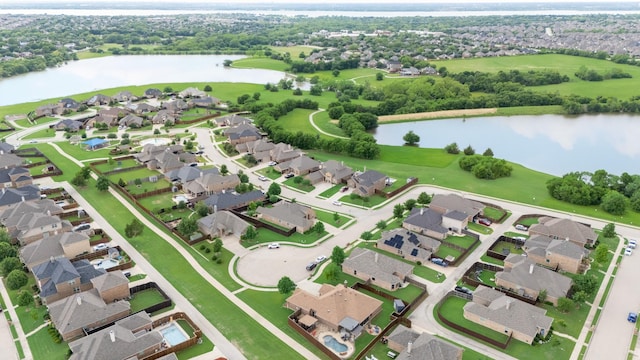 aerial overview of property's location featuring nearby suburban area and a nearby body of water