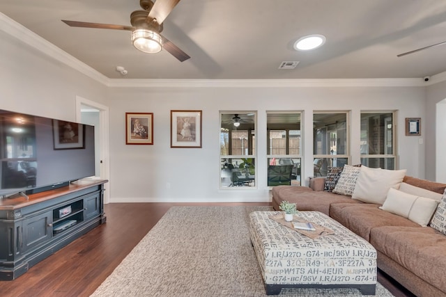 living area with a ceiling fan, ornamental molding, dark wood-type flooring, and baseboards