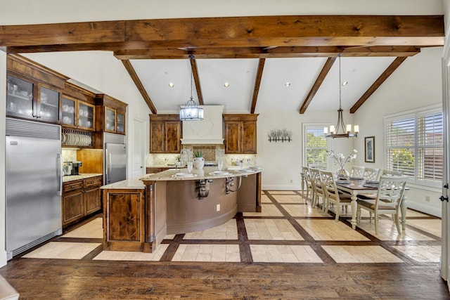 kitchen featuring built in refrigerator, a chandelier, light wood finished floors, and recessed lighting