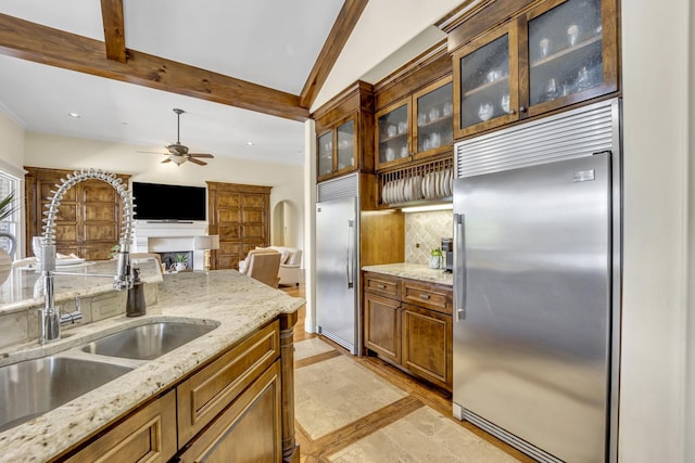kitchen with stainless steel built in fridge, a sink, backsplash, a ceiling fan, and recessed lighting