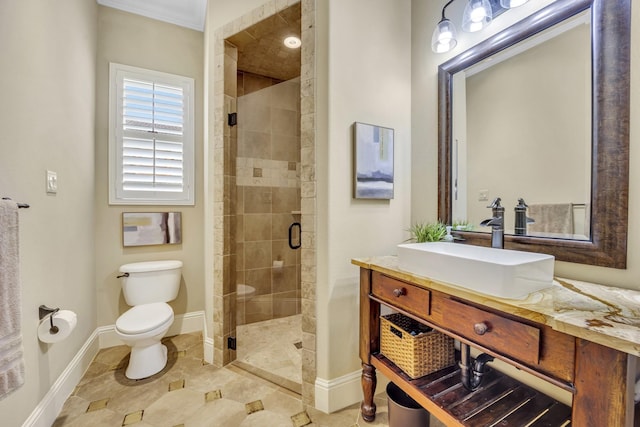 bathroom with toilet, a stall shower, baseboards, and vanity