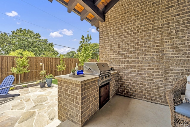 view of patio / terrace with area for grilling and fence