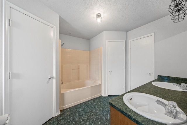 4627 Lexington St, Bellmead, TX 76705 - bathroom with a sink, a textured ceiling, shower / washtub combination, and tile patterned floors