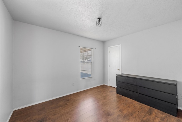 4627 Lexington St, Bellmead, TX 76705 - empty room with wood finished floors, a textured ceiling, and baseboards