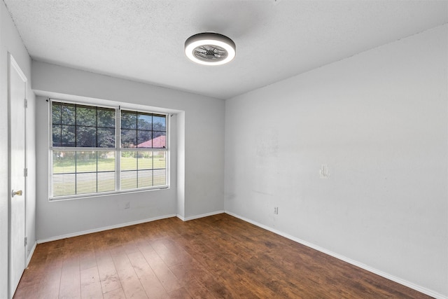 4627 Lexington St, Bellmead, TX 76705 - empty room with wood finished floors, baseboards, and a textured ceiling