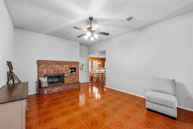 4627 Lexington St, Bellmead, TX 76705 - unfurnished living room featuring a ceiling fan, baseboards, a fireplace, and tile patterned flooring