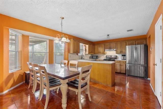 4627 Lexington St, Bellmead, TX 76705 - dining space with a chandelier, dark tile patterned flooring, a textured ceiling, and baseboards