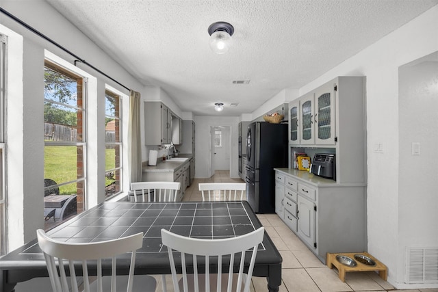 dining room featuring light tile patterned floors and a textured ceiling