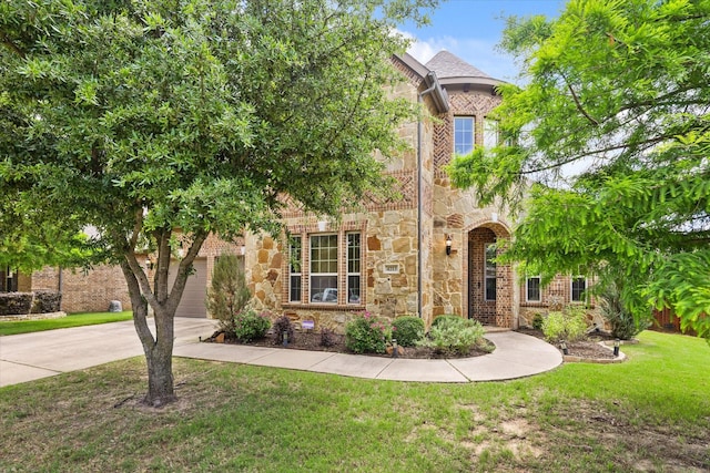 4213 Autumn Path Rd, Denton, TX 76208 - view of front of property with stone siding, concrete driveway, a front lawn, and a garage