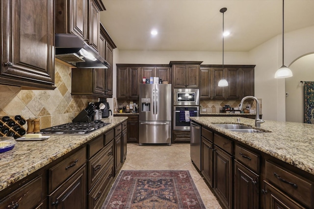 4213 Autumn Path Rd, Denton, TX 76208 - kitchen featuring stainless steel appliances, a sink, under cabinet range hood, tasteful backsplash, and pendant lighting