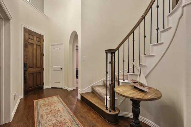 4213 Autumn Path Rd, Denton, TX 76208 - entrance foyer with arched walkways, wood finished floors, baseboards, stairs, and a high ceiling