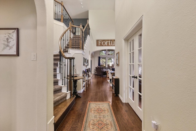 4213 Autumn Path Rd, Denton, TX 76208 - foyer entrance with french doors, arched walkways, a high ceiling, stairs, and wood finished floors