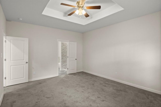 2024 Kraft St, Dallas, TX 75212 - empty room with a ceiling fan, carpet floors, a tray ceiling, baseboards, and a smoke detector