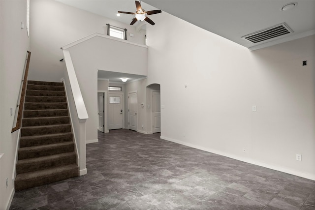 2024 Kraft St, Dallas, TX 75212 - unfurnished living room featuring a ceiling fan, arched walkways, a high ceiling, stairs, and baseboards
