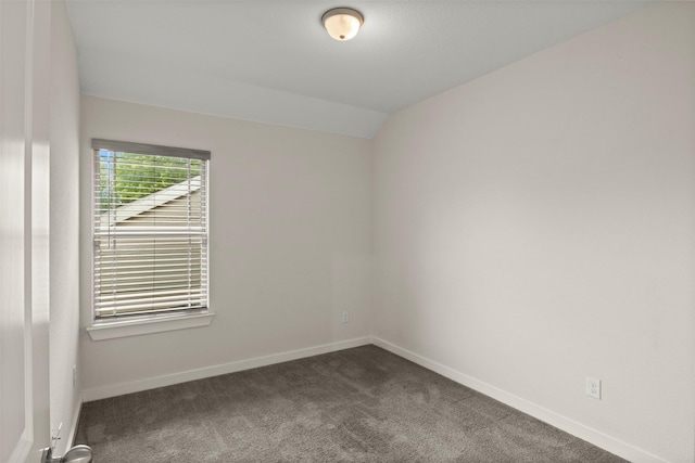 2024 Kraft St, Dallas, TX 75212 - empty room featuring dark carpet, baseboards, and vaulted ceiling