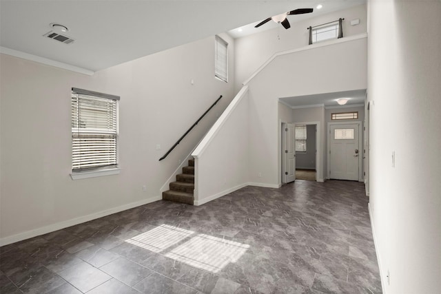 2024 Kraft St, Dallas, TX 75212 - unfurnished living room with plenty of natural light, ceiling fan, stairs, baseboards, and a high ceiling